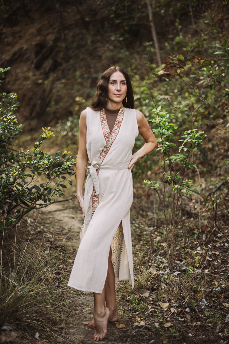 Woman in a white dress standing in a forest