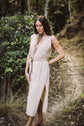 Woman in a flowing dress standing on a forest path
