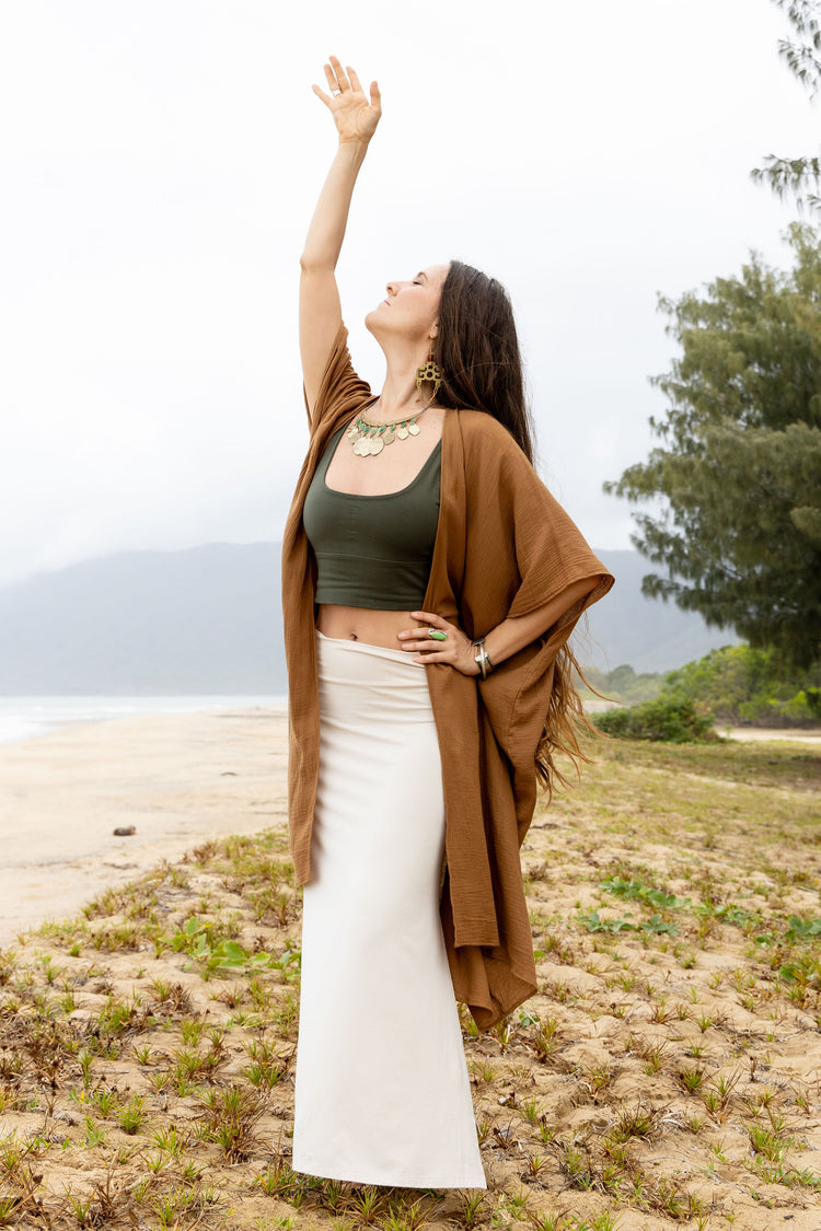 Side profile of Sacred Creations Adore Kaftan – flowing cotton gold fabric, perfect for yoga and relaxation"